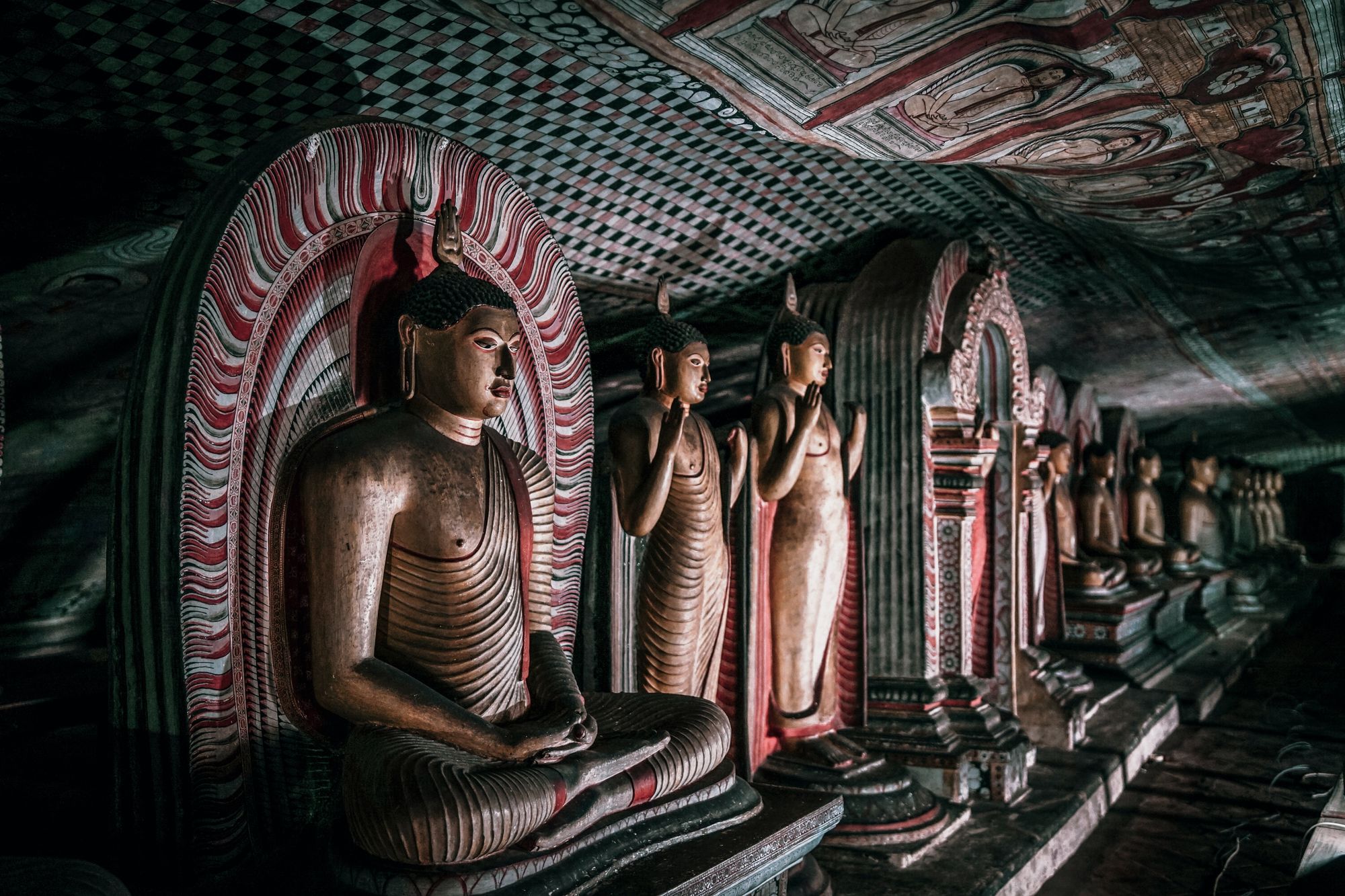 Buddha statues and paintings inside the Dambulla Cave Temple.