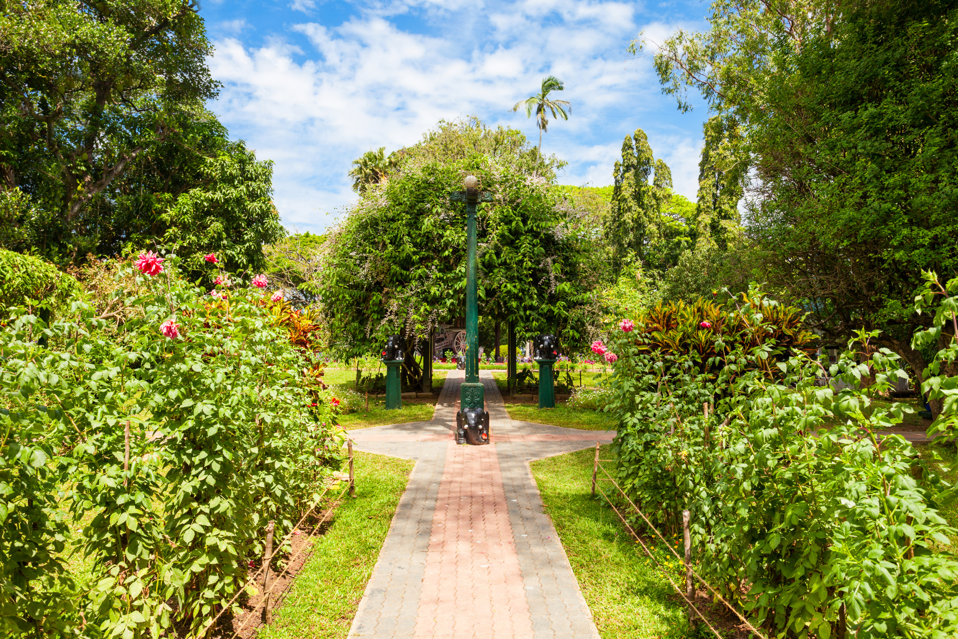 A pathway surrounded by leading through the gardens of Wales Park in Kandy, Sri Lanka
