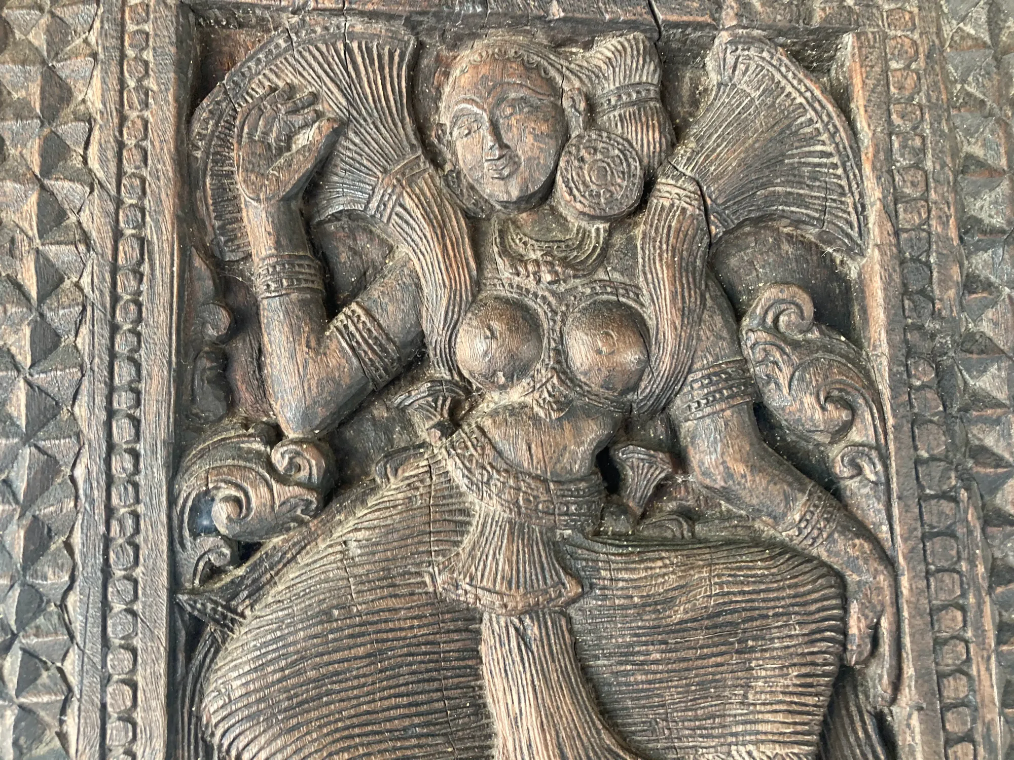 Wooden carving of a woman at Embekka Devalaya, Sri Lanka