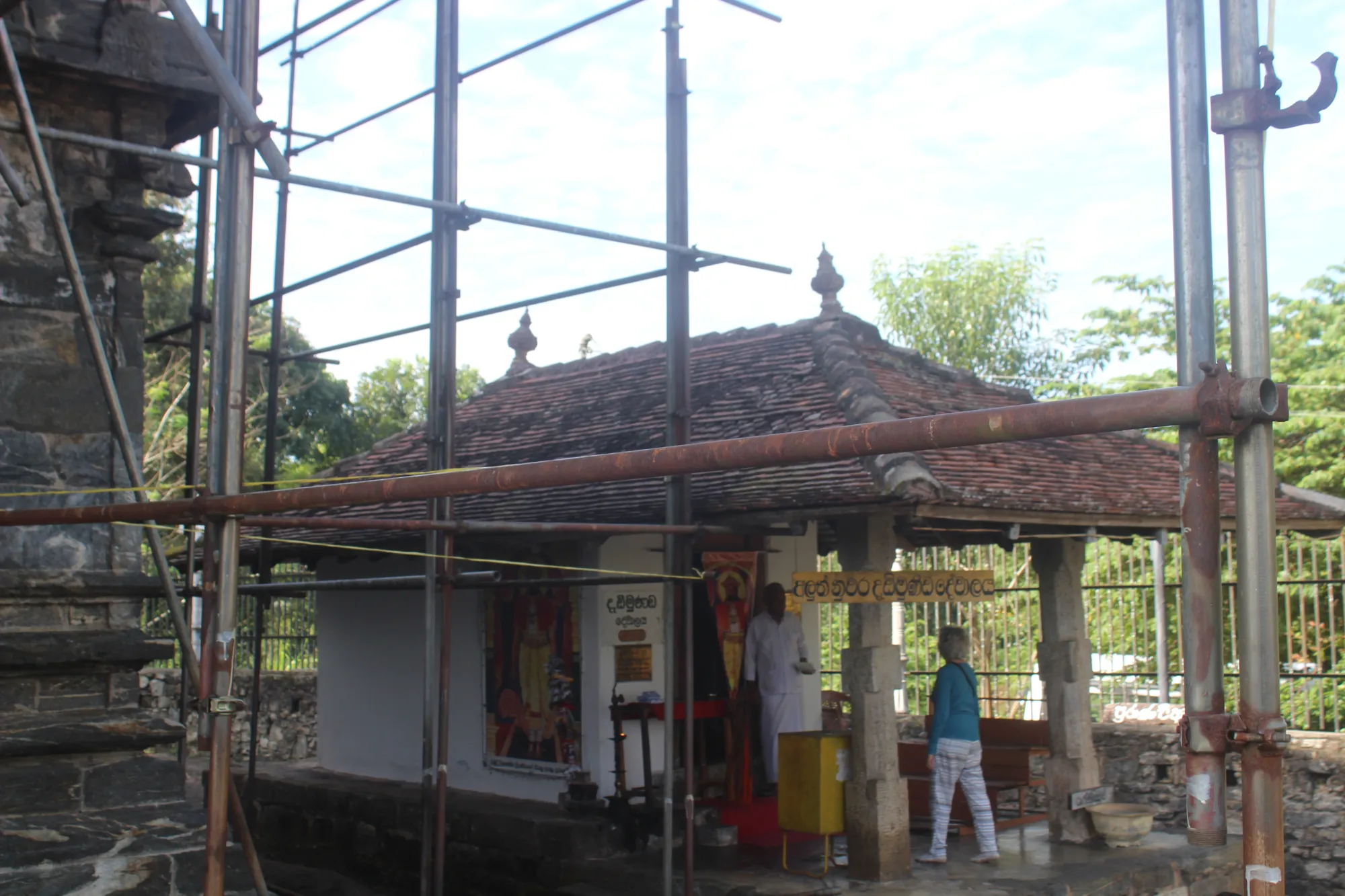 A tourist in Dedimunda Devalaya, at Gadaladeniya Temple, Sri Lanka.
