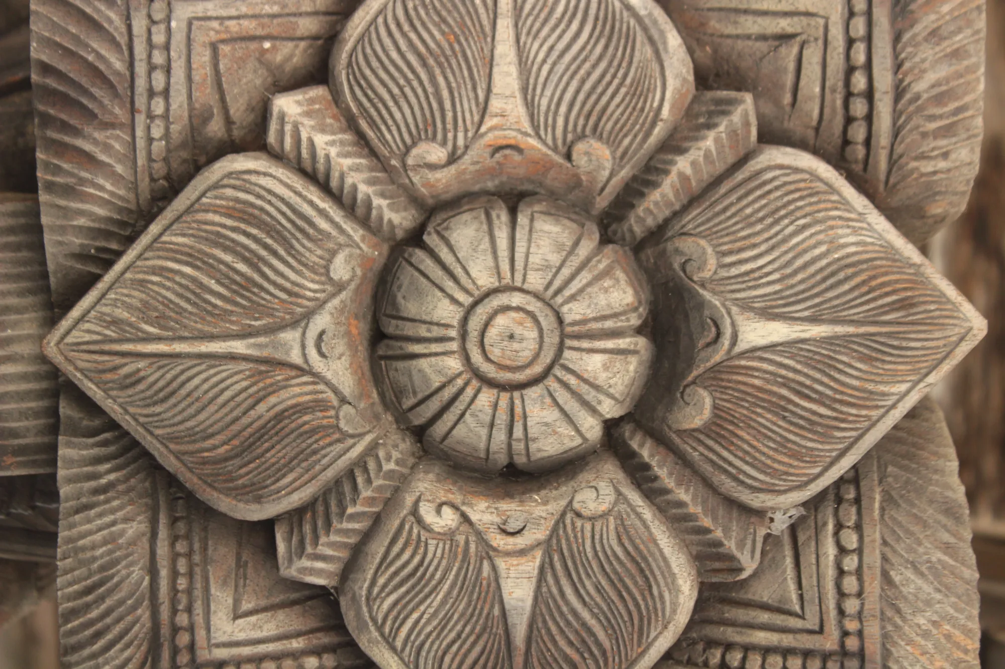 A wooden carving of a flower at Embekka Devalaya, Sri Lanka